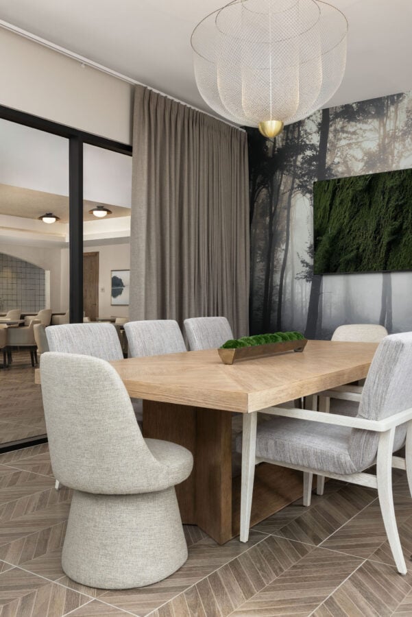 Sophisticated resident dining space with modern chairs and natural light