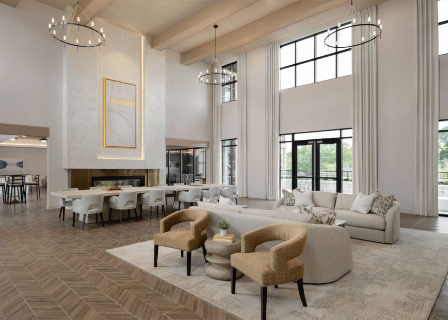 Spacious apartment clubhouse lounge with large windows and modern furniture
